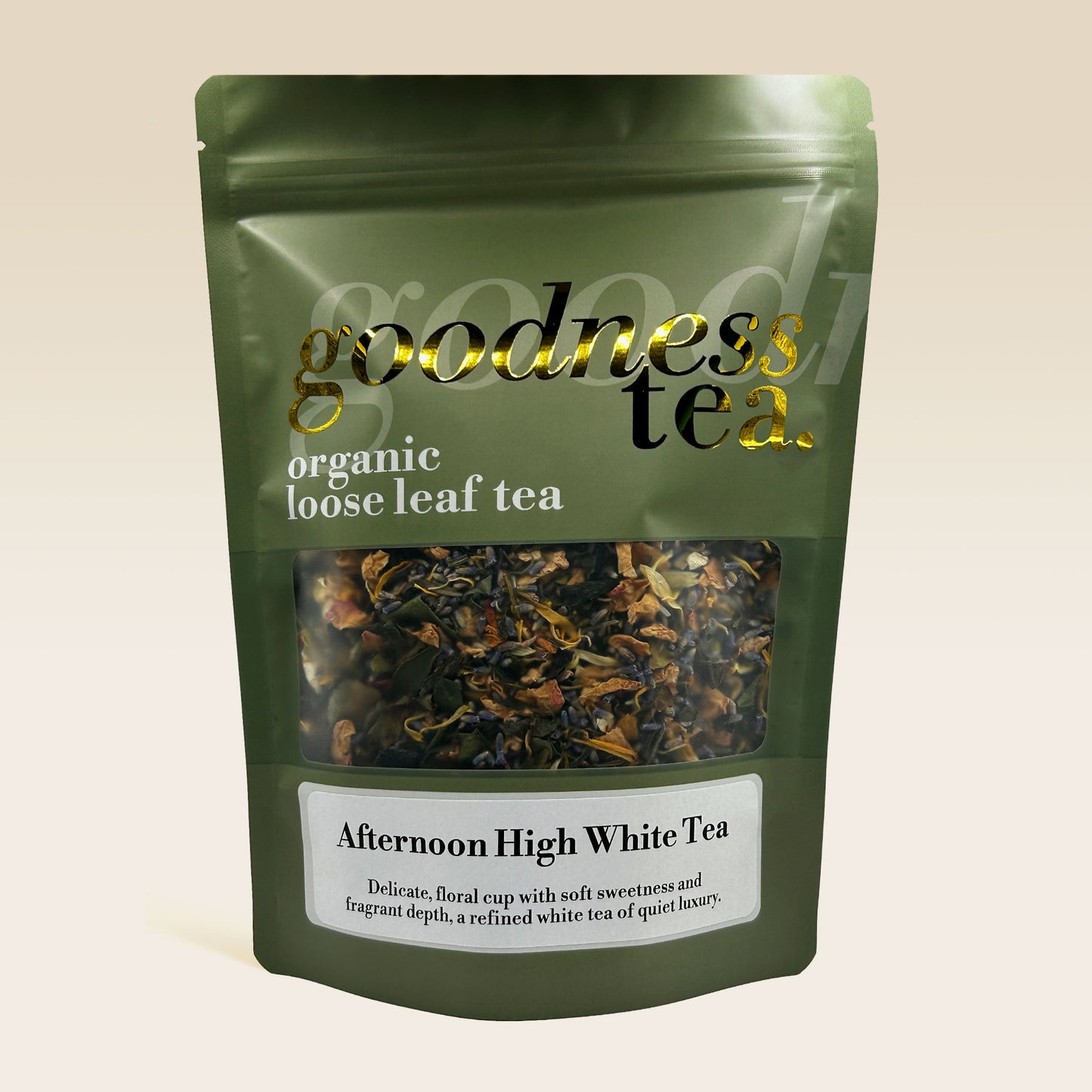 Green package of 'goodness tea' organic loose leaf tea on a beige background