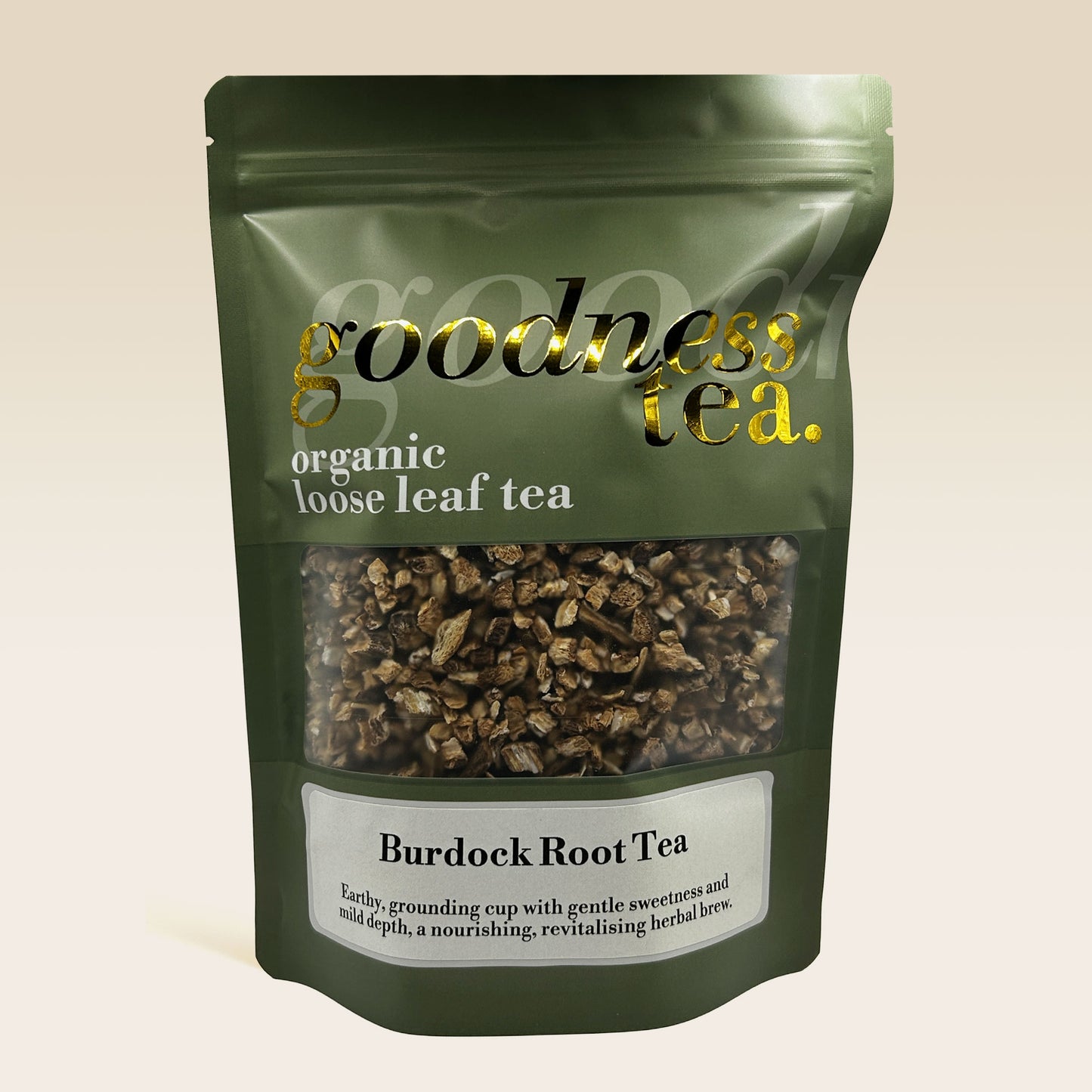 Green package of Burdock Root Tea from goodness tea on a beige background