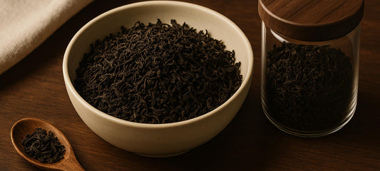 Loose black tea in a bowl, jar and wooden scoop