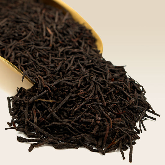 Close-up of Earl Grey black tea leaves on a white background