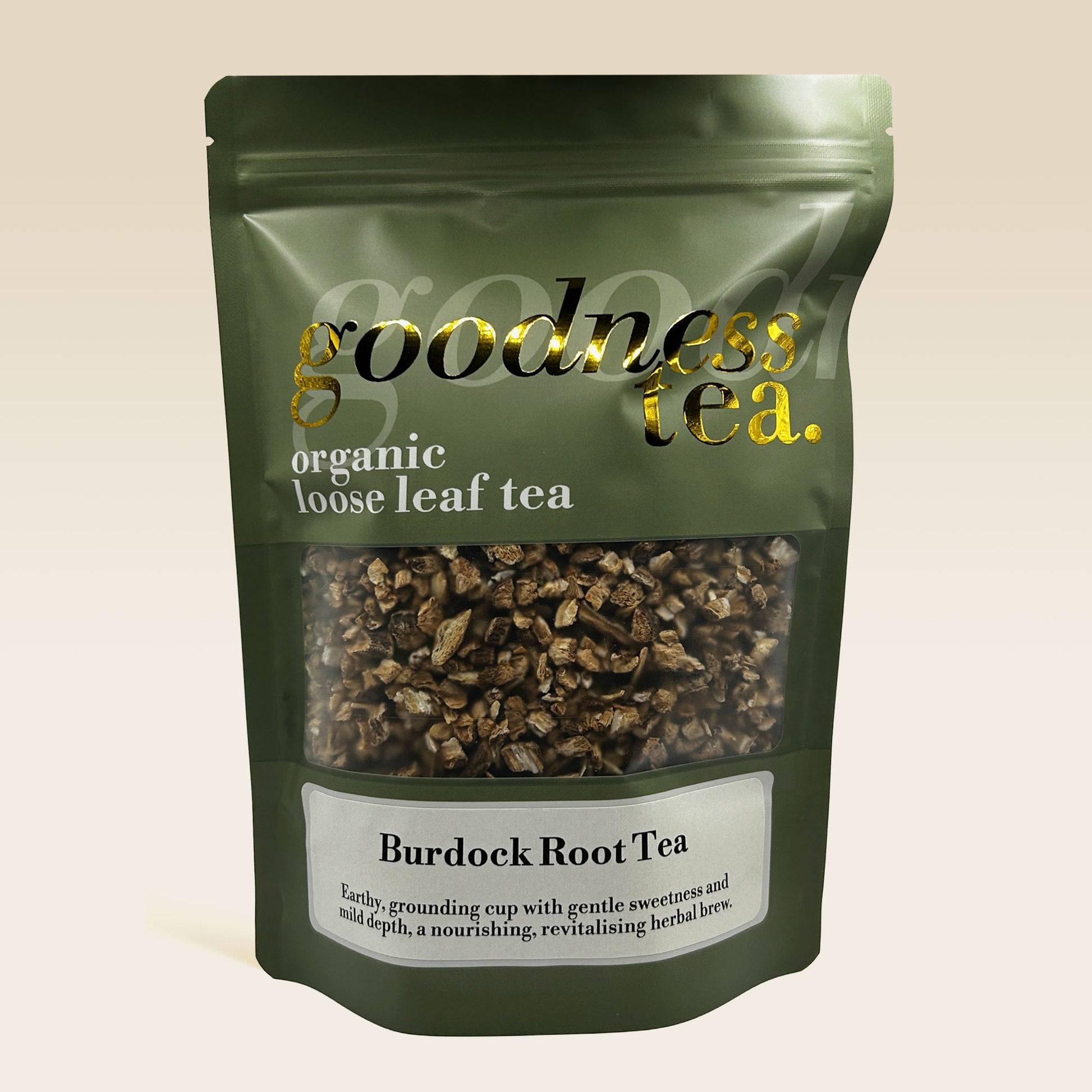 Green package of Burdock Root Tea from goodness tea on a beige background