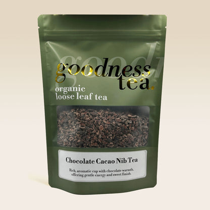 Green package of goodness tea with chocolate cacao nib tea on a beige background