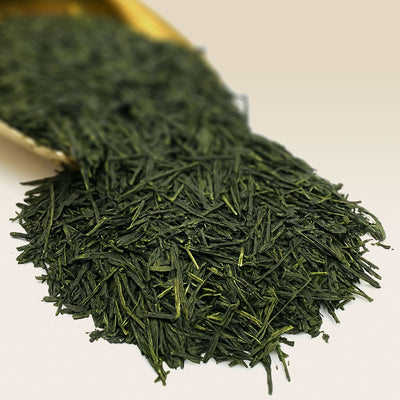 Japanese Green Gyokuro tea leaves on a white surface