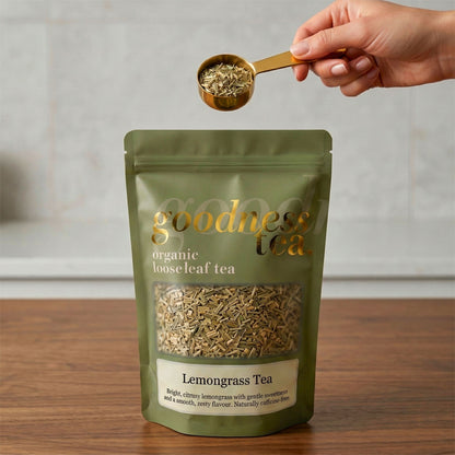 Goodness Tea package with a hand holding a scoop of lemongrass tea.
