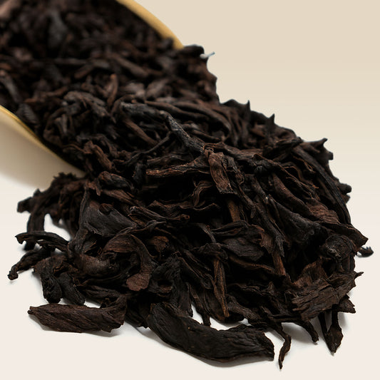 Close-up of Oolong tea leaves on a light beige background